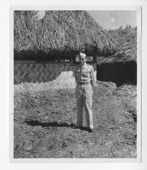 [Serviceman Posing in Front of Hut]