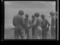 Photograph: [Negative of Soldiers Huddled Around a Rifle]