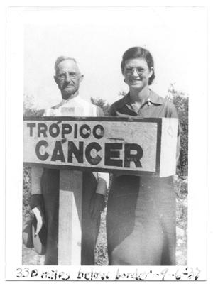 [Couple Standing with a Tropico Cancer Sign]