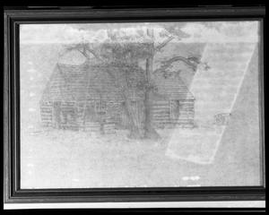 [Photograph of a Framed Picture of a Log House and Cannon]