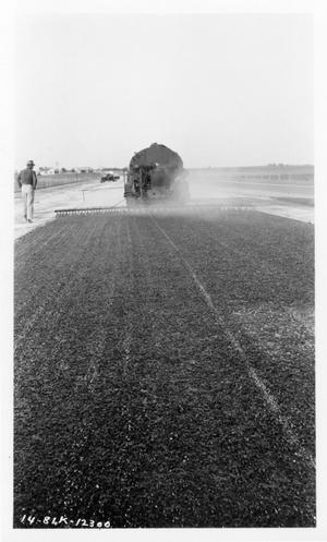 Primary view of object titled '[Photograph of Construction Vehicle Applying Surface Treatment]'.