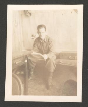 Primary view of object titled '[Bob Brinker Sitting on Cot]'.