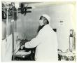 Photograph: [Dr. Herman A. Barnett Works on a Patient Before Surgery]