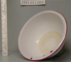Primary view of object titled '[White enameled bowl with 7/8 lip trimmed with red.]'.