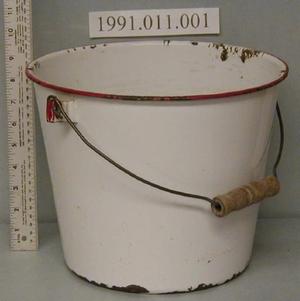 Primary view of object titled '[White enameled pail with red trim on lip]'.