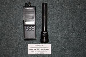 [Image of Arlington Police Officer Joey Cushman's flashlight and portable radio transceiver]
