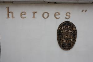 [Heroes' Park "We Remember Wall" brass police badge emblem]