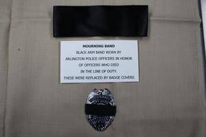 [Image of an APD mourning band and badge cover]