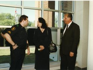 Primary view of [Arlington Police Officer Chip Oxendine with his parents]