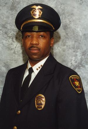 [Arlington Police Chief Theron Bowman, portrait with hat on head]