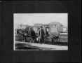 Photograph: [John F. Phenegar in front of an Osage Dairy wagon]