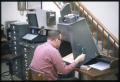 Photograph: [Man Uses a Microform Machine at Austin Public Library]