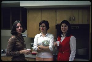 [Three Women Stand in a Kitchen at a LibraryParty]