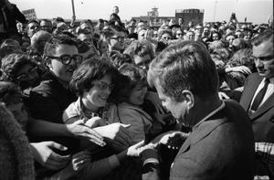 [President and Mrs. Kennedy greeting crowds at Love Field]