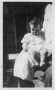 Photograph: [Mary Jones at four months old, sitting on a man's lap]