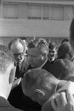 Primary view of object titled '[Reporters listen to Senator Yarborough giving a statement outside Parkland Hospital]'.