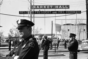 Primary view of object titled '[Dallas Police officers standing guard outside the Dallas Trade Mart]'.