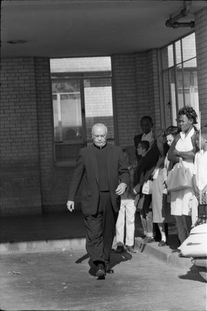 [Father James N. Thompson leaving Parkland Hospital]
