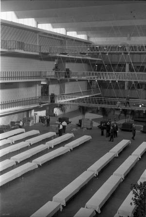 Primary view of object titled '[Banquet tables being set up at the Dallas Trade Mart]'.