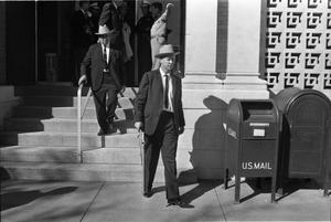 Primary view of object titled '[Dallas Police officers exiting the Texas School Book Depository]'.