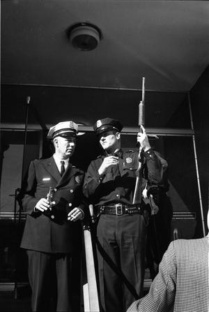 [Police officers at the entrance to the Texas School Book Depository]