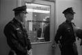 Photograph: [Dallas Police officers guarding the Homicide and Robbery Bureau door]