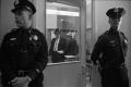 Photograph: [Image of police officers guarding the door of the Homicide and Robbe…