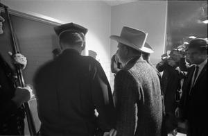 Primary view of object titled '[Police and detectives escorting Oswald's body into the morgue]'.