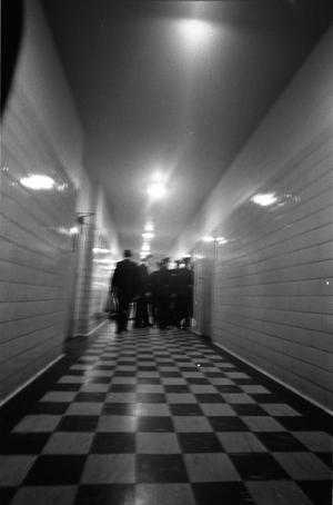 [Police officers in the hallway outside the Parkland Hospital morgue]