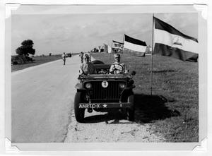 Primary view of object titled 'Two men in jeep at Camp Wallace'.