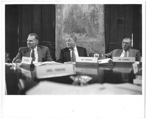 Primary view of object titled '[Lamar Fleming, Jr. seated with Mr. Erickson and Mr. Kleberg in meeting with tapestry in background]'.