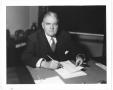 Thumbnail image of item number 1 in: '[George A. Hill, Jr. behind desk with papers]'.
