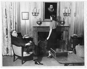 [George A. Hill, Jr. with daughter Joanne standing by fireplace]