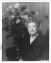 Photograph: [Ima Hogg seated in front of floral arrangement]