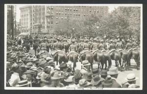 Primary view of object titled '[Calvary Soldiers on horseback parading in front of San Jacinto Plaza]'.