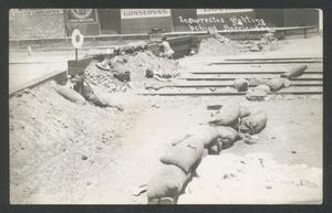 Primary view of object titled '[Insurrectos fighting behind Barricade]'.