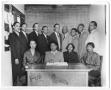 Photograph: [Group of Businesspeople in Front of Chalkboard]