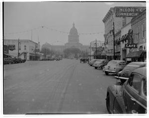 [A view down the snow covered street in front of the Capitol]