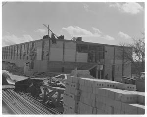 Primary view of object titled '[Bricks in front of the construction of Pearce Jr. High School]'.