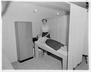 Primary view of object titled '[Woman getting hair washed at Delwood Beauty Shop]'.