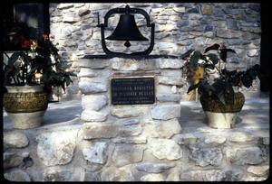 Primary view of object titled '[Bell, Plaque, and Flower Vases on Stone Construction]'.