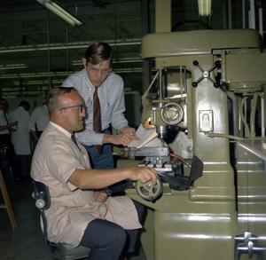 Two Unidentified Men at a Drill Press