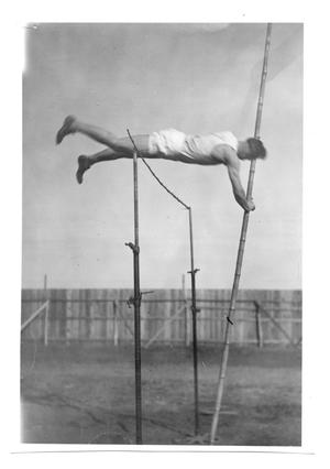 [Photograph of Odus Mitchell in the 12 ft. pole vault in the early twenties]