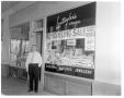 Photograph: Mr. Leutwyler in front of store