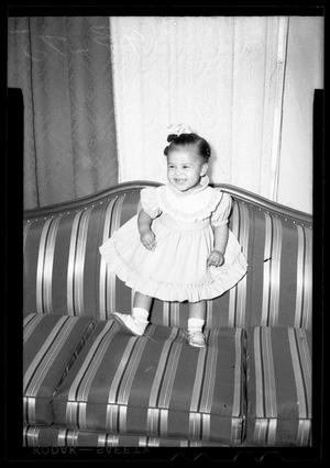 [Photograph of a Young Child Standing on a Couch]
