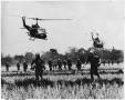 Photograph: Combat Soldiers Running in Field with Helicopters Overhead