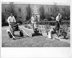 Student laborers mowing lawn and gardening in front of Kilian Hall