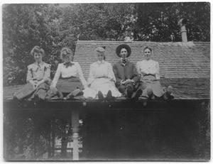 [Photograph of People Sitting on a Roof]