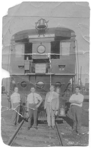 Primary view of object titled '[Men Standing in Front of Train]'.