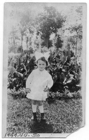 [Child in Front of Plant]